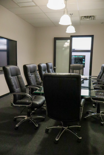 A clean conference room with empty chairs.